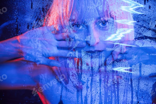 Preview: Looking at camera. Stylish woman with white hair is behind wet transparent plastic sheet