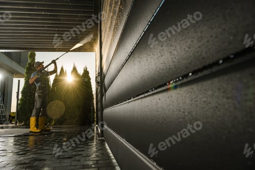 Preview: Caucasian Man Power Washing His Modern Aluminium Car Port