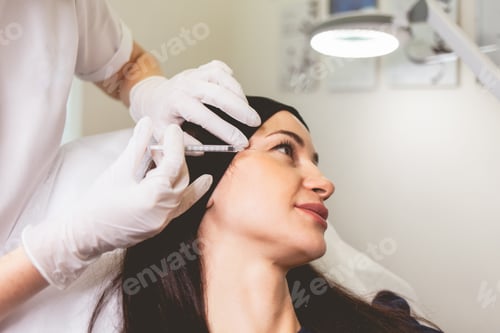 Preview: Cosmetologist makes anti-aging injections for her patient. Woman takes care of herself