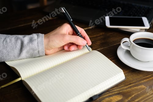 Preview: Woman writing by left hand in notebook