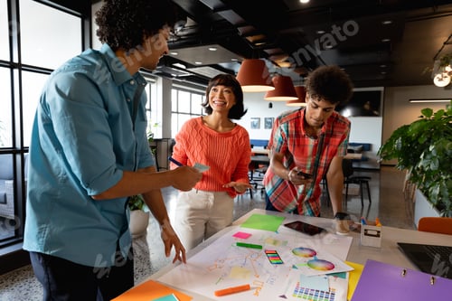 Preview: Creative multiracial colleagues planning business strategy in meeting at office