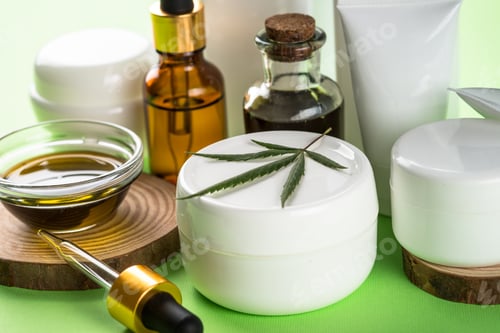 Preview: Cannabis cosmetic products on green background close up