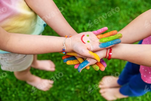 Preview: Hands of a child with a drawn smile. Selective focus.