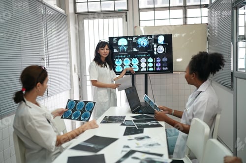 Preview: Group of doctors looking at X-ray on medical conference, discussing issues
