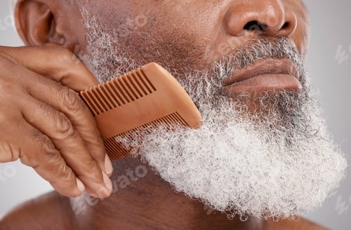 Preview: Senior man, hands and beard with comb in grooming, beauty or skincare hygiene against a studio back