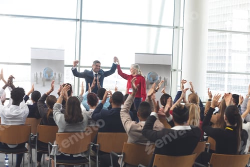 Preview: Diverse business people applauding and celebrating at business seminar