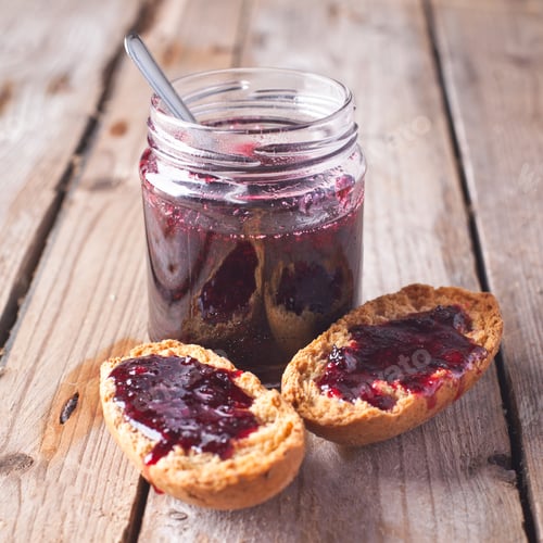 Preview: black currant jam in glass jar and crackers
