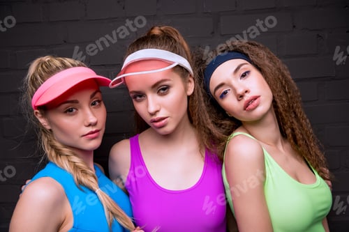 Preview: portrait of confident women in fitness clothing on black