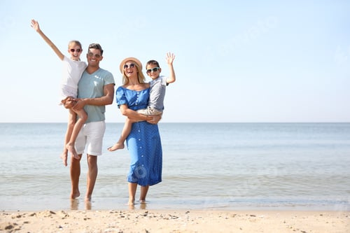 Preview: Happy family at beach on sunny summer day