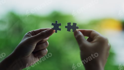 Preview: a woman holding and putting a piece of white jigsaw puzzle together