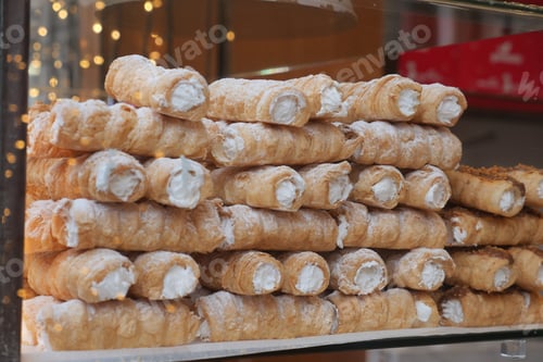 Preview: Stacked layers of flaky pastry rolls,