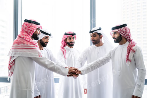 Preview: Arab businessmen wearing emirati and saudi kandura meeting in office