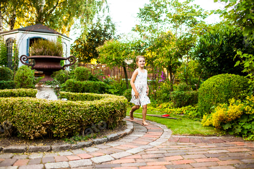 Preview: Full length of happy girl running in garden