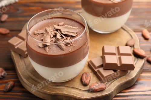 Preview: Delicious panna cotta with chocolate and cocoa beans on wooden table, closeup