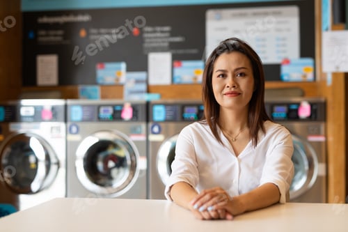 Preview: Portrait of woman sitting in laundry shop