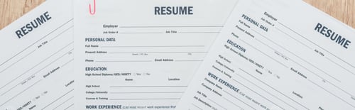 Preview: panoramic shot of print resume templates on wooden surface