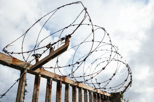 Preview: Closeup shot of barbed wire on a cloudy sky background