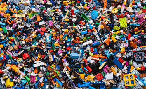Preview: Colorful background of mixed plastic bricks toys. Building blocks in multiple colours.