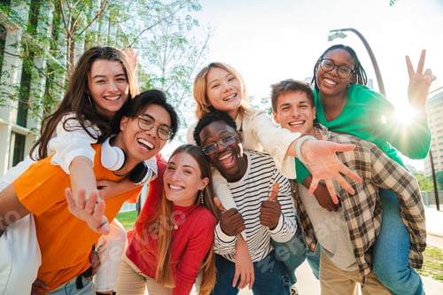 Preview: Big group of multiracial young student people smiling, gesturing and looking at camera. Happy