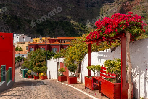 Preview: Red benches on the streets in the village of Agulo in the north of La Gomera in summer, Canary