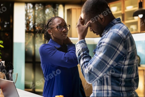 Preview: Unhappy black couple shouting during an argument indoors