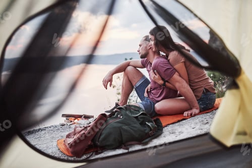 Preview: View from tent of couple lying a view of lake during hiking trip. avel Lifestyle concept adventure