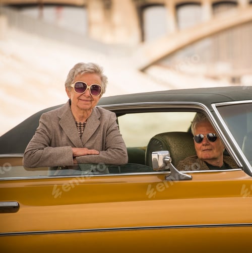 Preview: Portrait of cool senior couple with their classic automobile