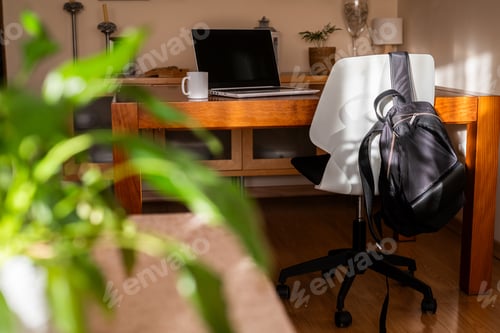 Preview: Home office workspace featuring laptop and mug on desk