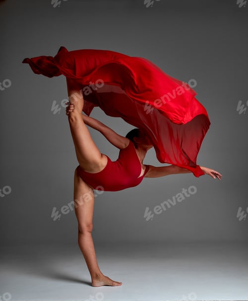 Preview: Ballerina Jumping in Pointe Shoes with Flying Red Cloth, Modern Ballet Dance, Isolated Gray