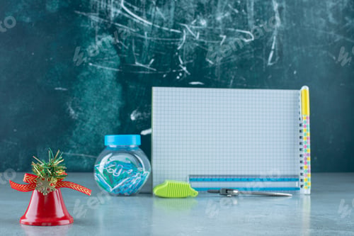 Preview: Bundle of stationery products and a decorative bell on marble background