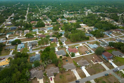 Preview: Aerial landscape view of suburban private houses between green palm trees in Florida