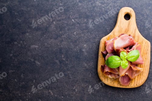 Preview: Prosciutto with rosemary on a black background.