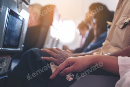 Preview: Passenger sitting on a seat row in cabin