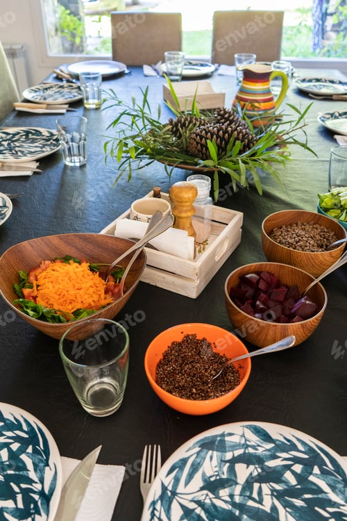 Preview: Bowls full of vegetables and legumes over the lunch table. Vegan food