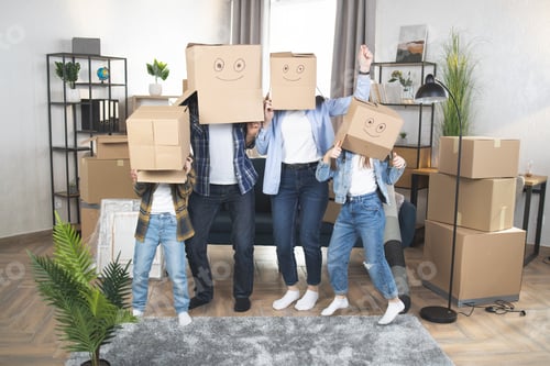 Preview: Parents and kids with boxes on heads standing at new house