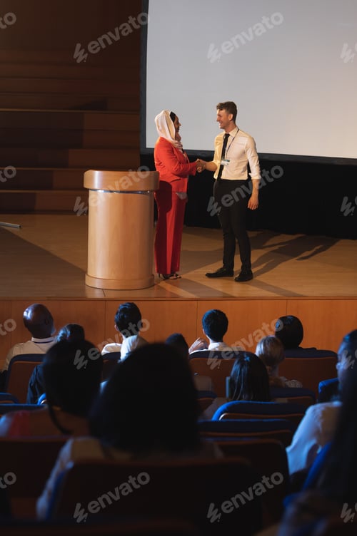 Preview: Business colleague standing with each other in front of the audience in auditorium