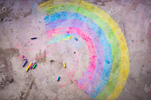 Preview: A rainbow painted in chalk on a concrete floor.