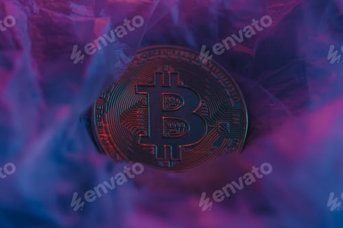 Preview: Bitcoin coin under neon on textured surface. Photo for presentation and news.