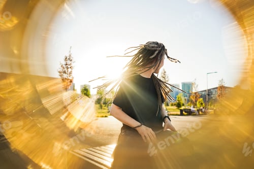 Preview: Portrait of young happy woman with dreadlocks
