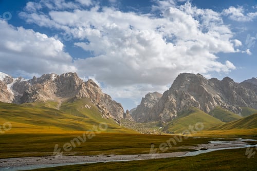 Preview: Serene river landscape with towering mountain backdrop