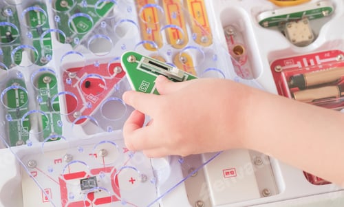 Preview: girl's hand holding detail of innovative modern constructor.