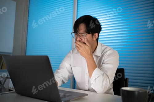 Preview: Tired Asian business man falling asleep at table Alone Working holding his head on hands after late