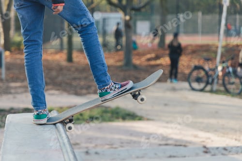 Preview: Young girl skater standing on skateboard at the skate park on ramp