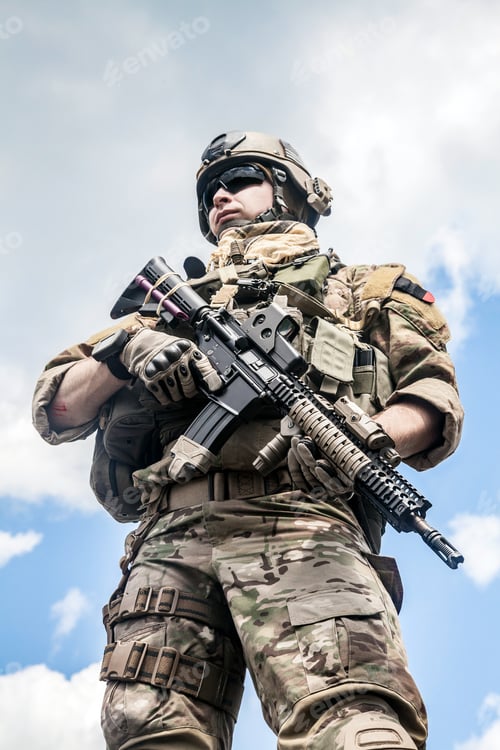 Preview: Soldier Holding Rifle in Camouflage Urban Setting