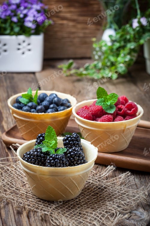 Preview: Blackberries, raspberries and blueberries in a waffle bowls.