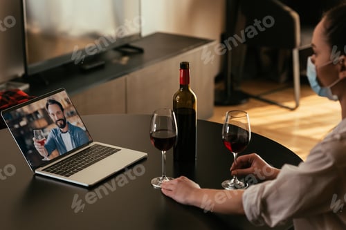 Preview: selective focus of young woman in medical mask having video chat with boyfriend near glasses and