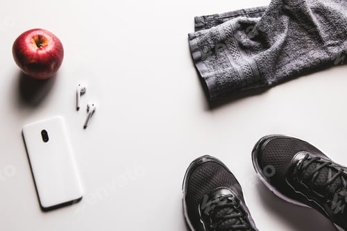 Preview: Mockup mobile cellphone with earphone and running shoes on white background. Healthy lifestyles