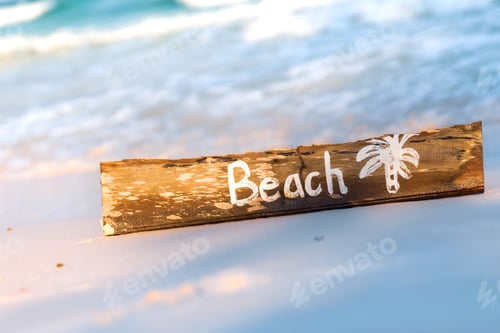 Preview: Wooden sign with lettering on the beach