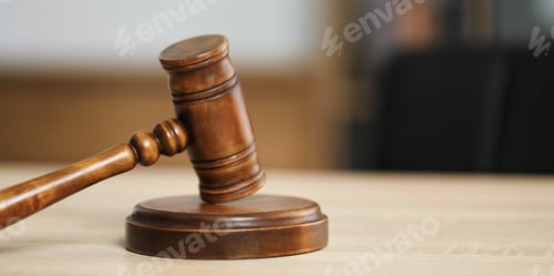 Preview: Judge's gavel on wooden table in office, closeup. Space for text