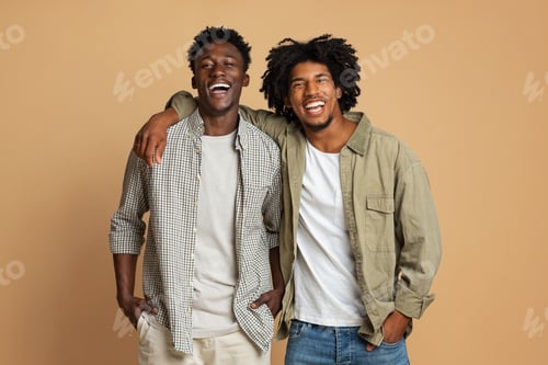 Preview: Portrait Of Two Happy Black Guys Embracing While Posing Over Beige Background